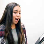 Learning the fundamentals of singing like breathing, posture and diction.
