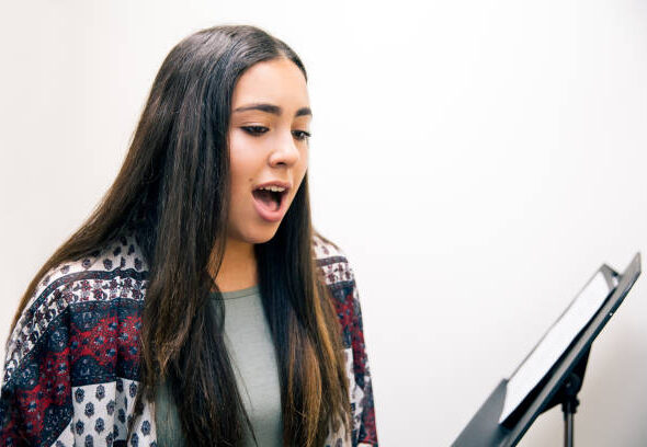 Learning the fundamentals of singing like breathing, posture and diction.